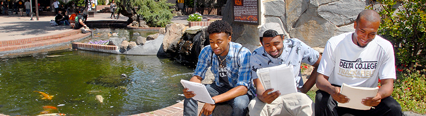 Students studying in front of the Koi Pond